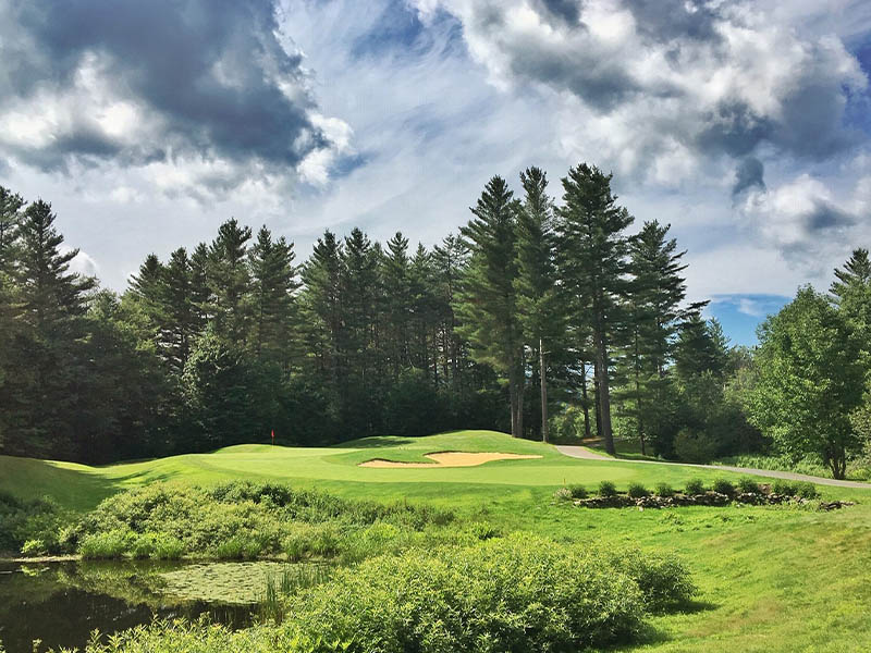 Green Mountain National golf course with water, hills and pine trees